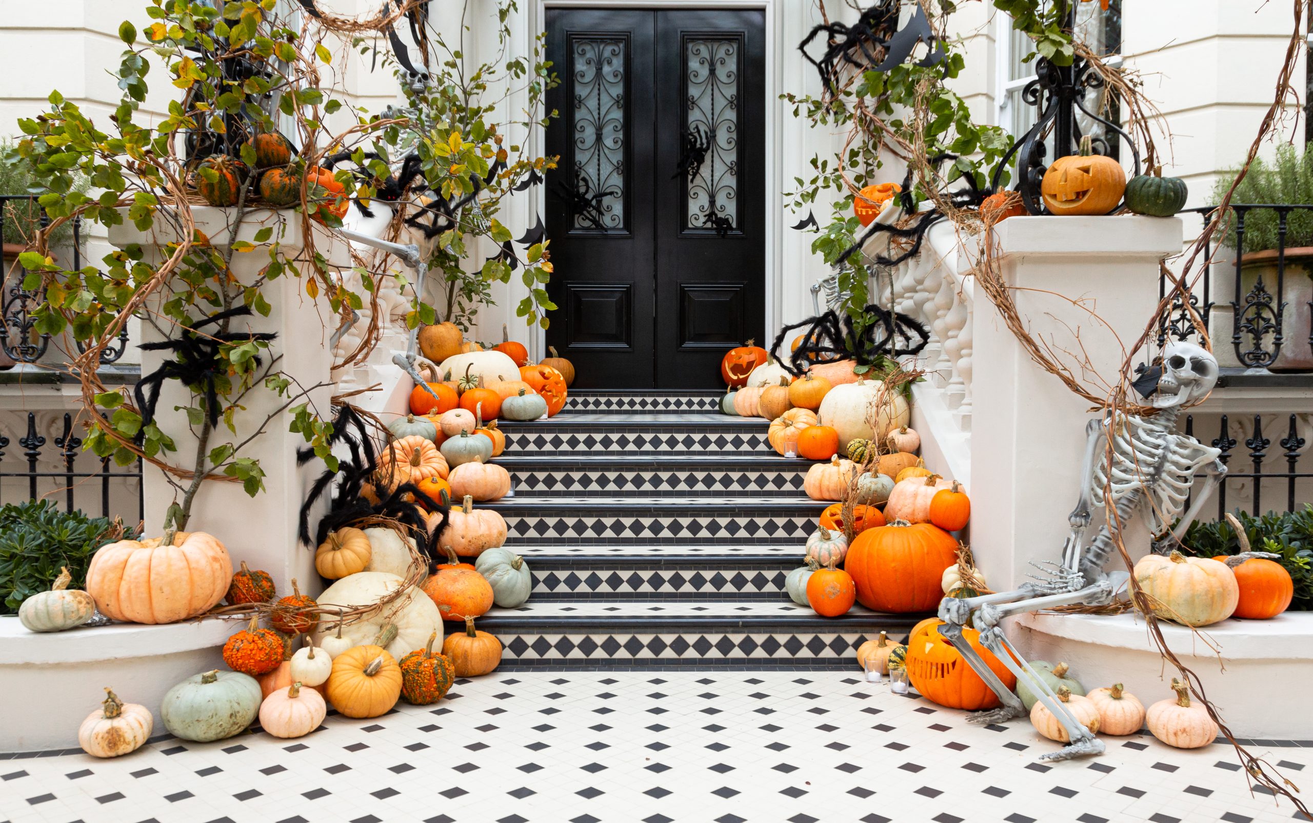 Display of Halloween pumpkins on front steps of house